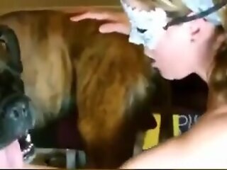 Blonde babe wants to feel the dog's dick and play with it